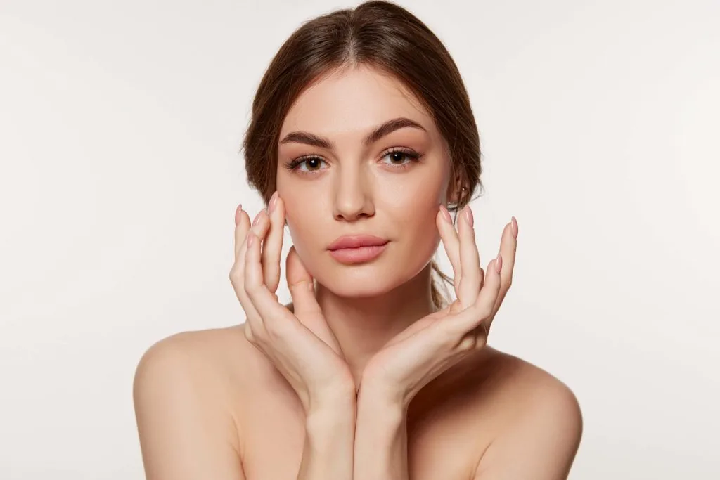 Clear Skin Young Woman with Fingers on Cheek | Sutera Spa in Flower Mound, TX