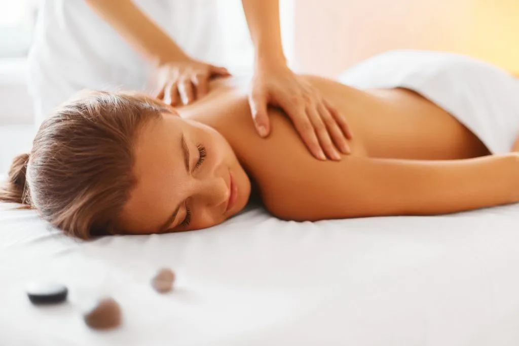 Lying Woman Receiving Massage Treatment | Sutera Spa in Flower Mound, TX